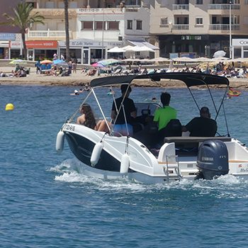Embarcación a motor con gente en el mar.